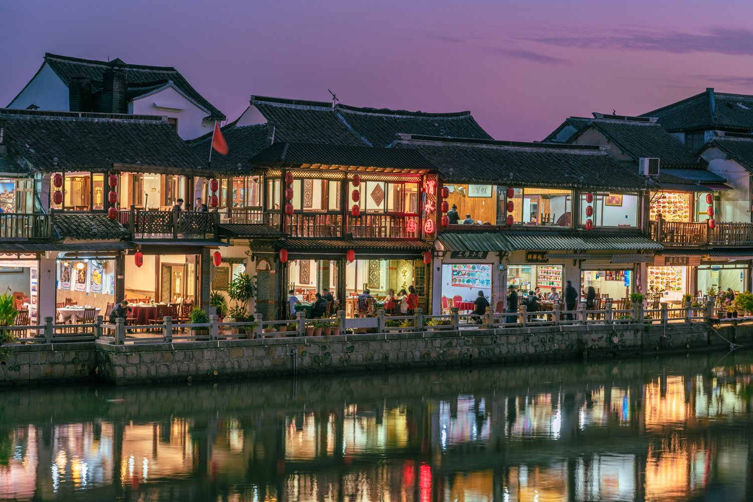 SHANGHAI, CHINA, NOVEMBER 01: Chinese restaurants along the riverside at Zhujiajiao ancient water town in the evening on November 01, 2019 in Shanghai